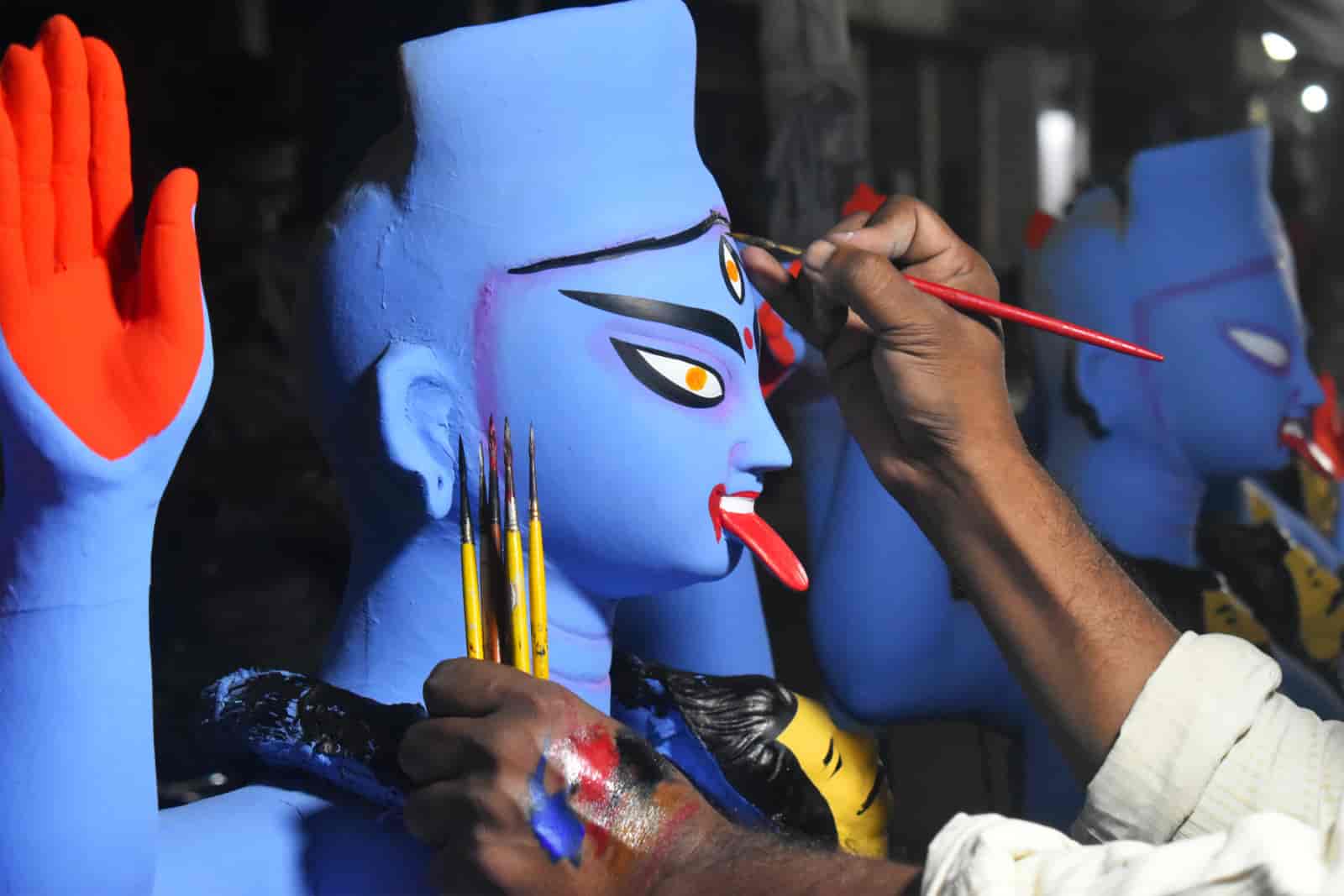 An idol maker paints an idol of Kali at a workshop in Kolkata, India on November 9, 2023 (Sudipta Das/NurPhoto via Getty Images)