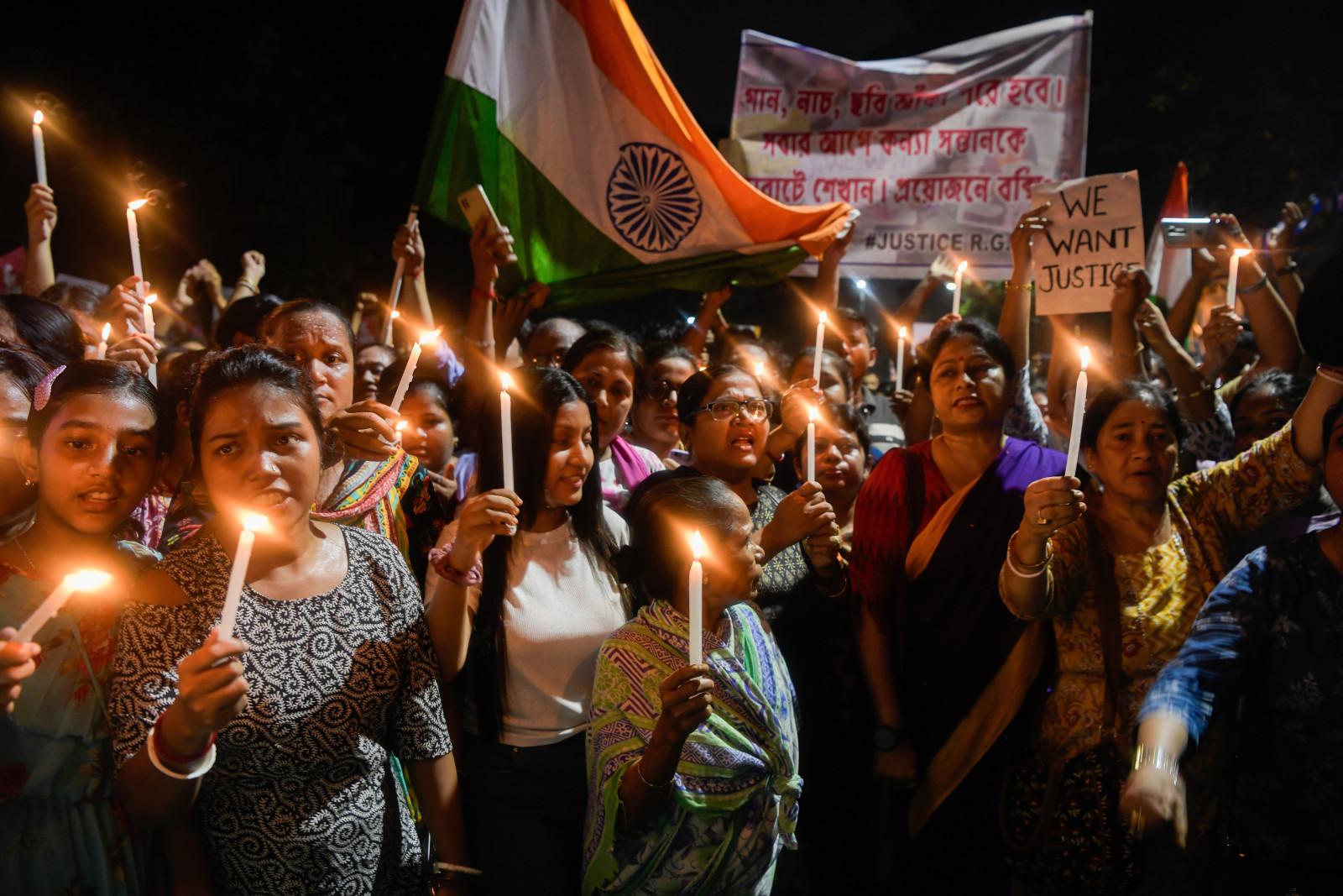 Women hold lit candles as they take part in a vigil named "Reclaim the Night" in Kolkata on August 15, 2024 (Photo by Avijit Ghosh/SOPA Images/LightRocket via Getty Images)