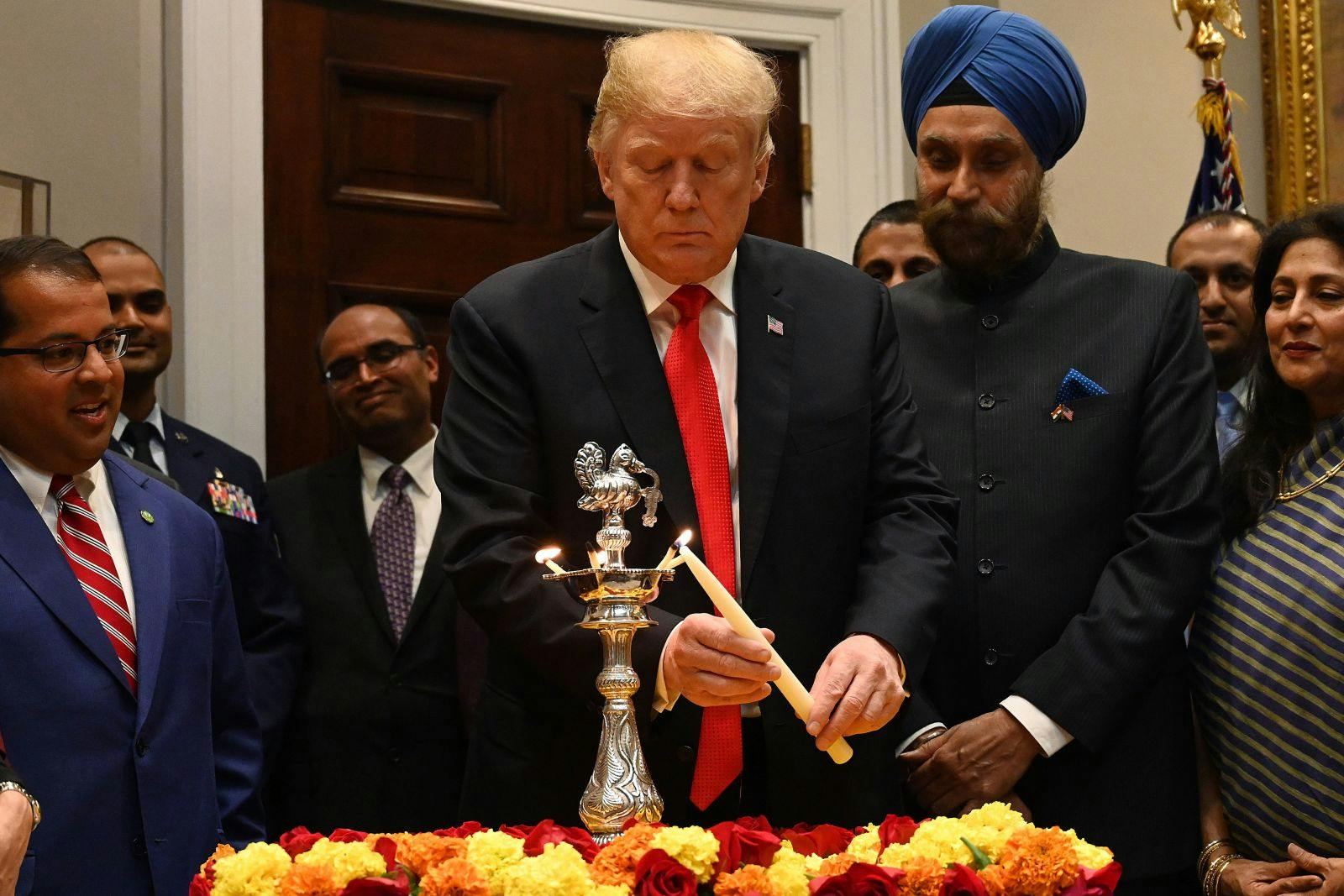 US President Donald Trump lights the Diya during the Diwali ceremonial at the White House in Washington, DC, on November 13, 2018. (JIM WATSON/AFP via Getty Images)