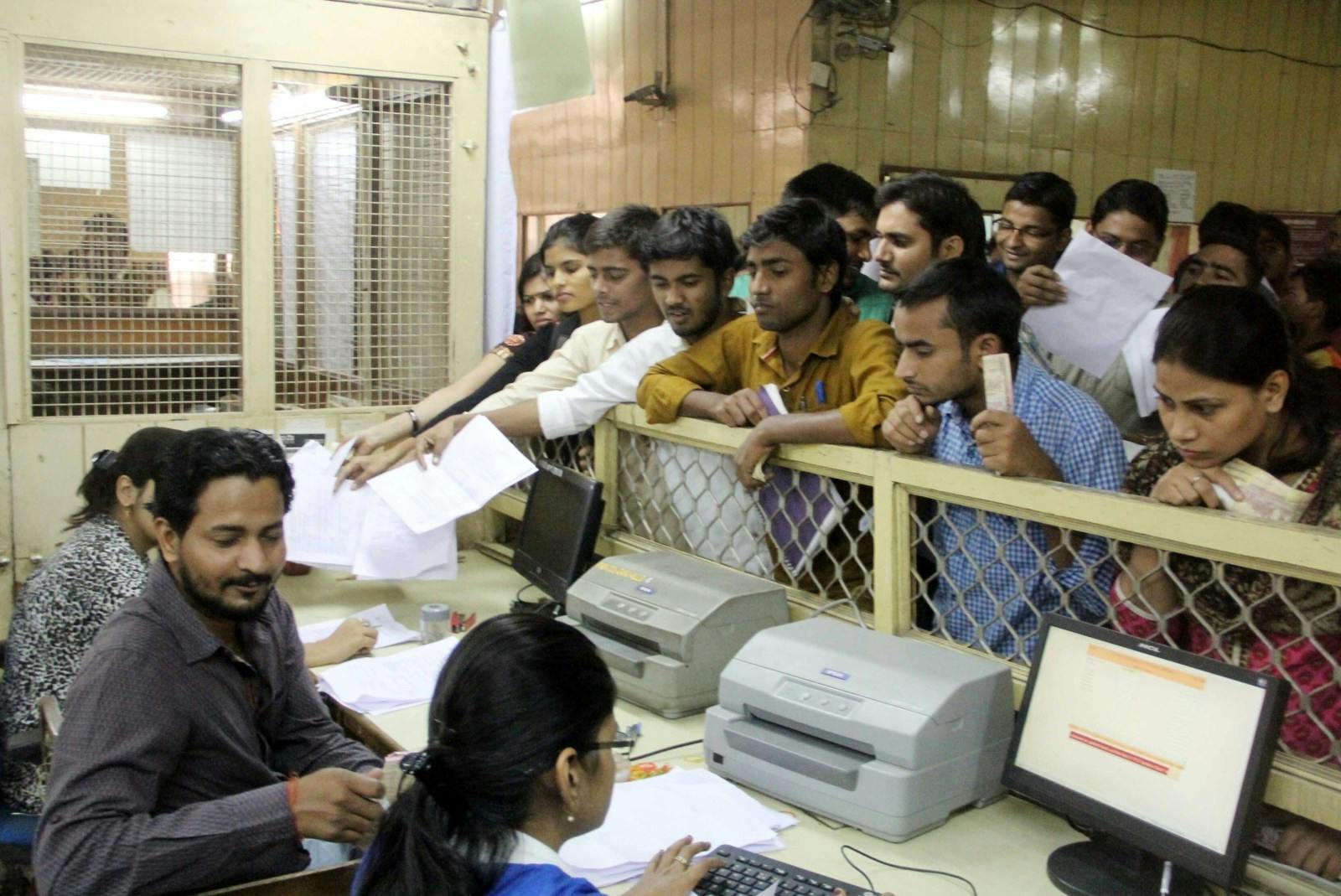 People stand in a queue to exchange Rupees 500 and 1000 notes at Punjab National Bank in Allahabad on November 10, 2016 (Amar Deep/Pacific Press/LightRocket via Getty Images)