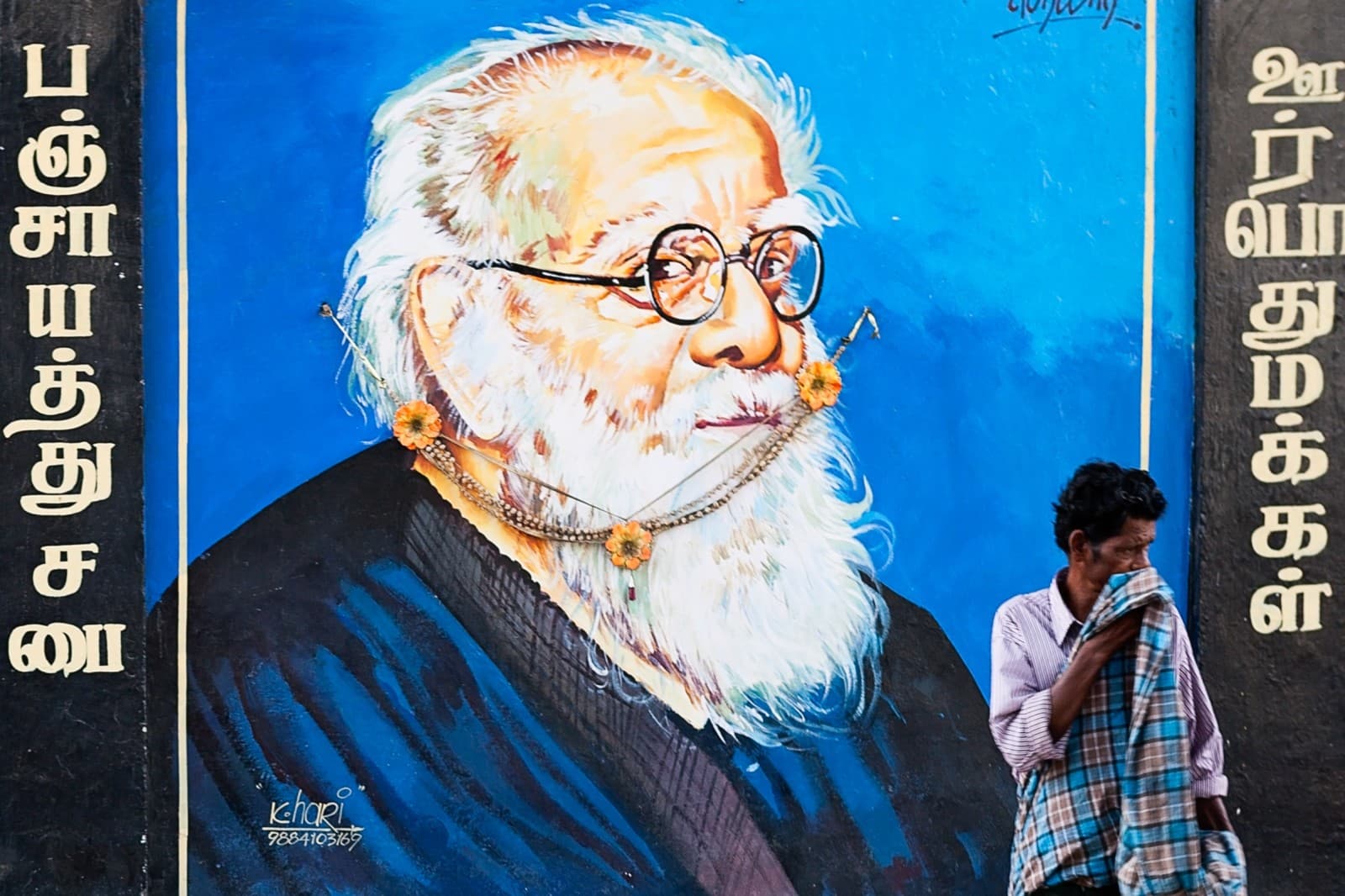 Dalit man standing by wall painting of Erode Venkata Ramasamy, famous for their fight against discrimination, in Chennai, Tamil Nadu (Marji Lang/LightRocket via Getty Images)